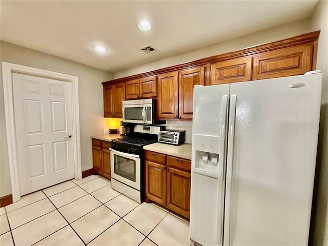 kitchen featuring light tile patterned floors and stainless steel appliances