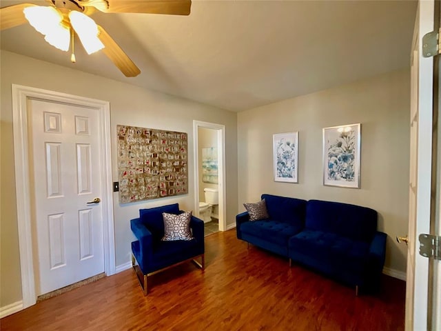 living room featuring dark hardwood / wood-style floors and ceiling fan