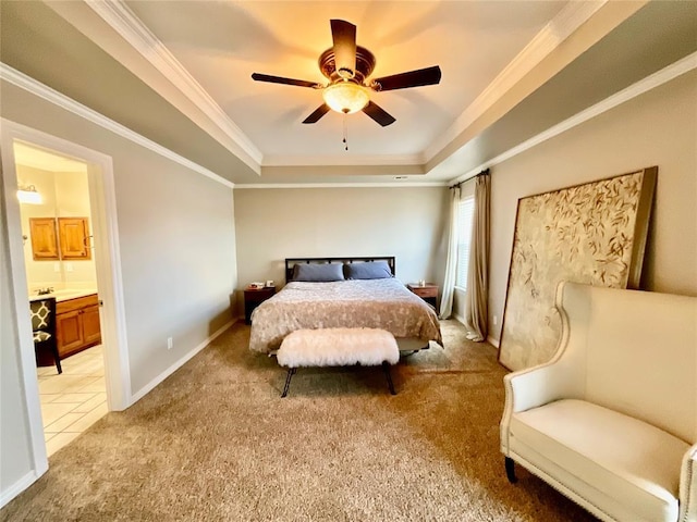 bedroom with a raised ceiling, ensuite bath, ceiling fan, and light colored carpet