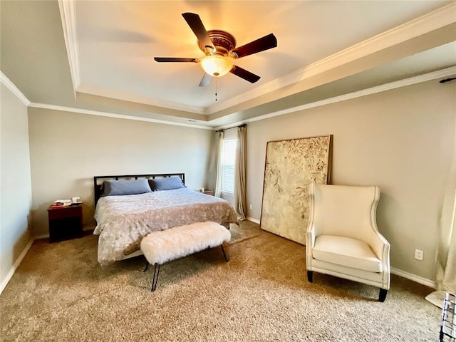 carpeted bedroom featuring ceiling fan, crown molding, and a tray ceiling