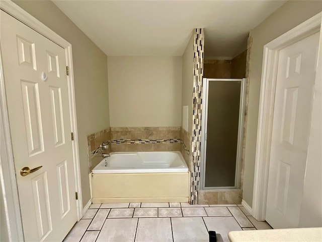 bathroom featuring tile patterned flooring and independent shower and bath