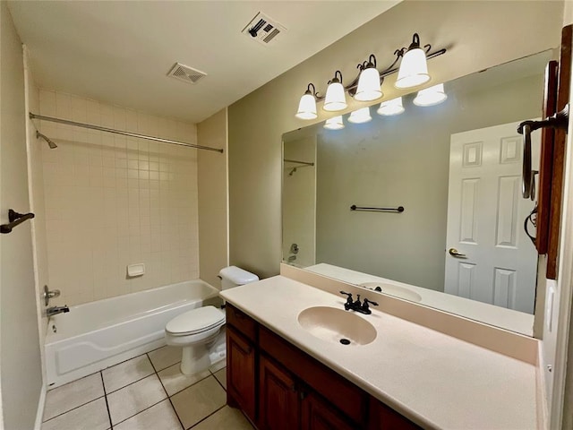 full bathroom with tile patterned floors, tiled shower / bath, vanity, and toilet