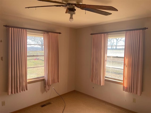 carpeted empty room with ceiling fan