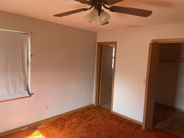 unfurnished bedroom featuring carpet flooring, a closet, and ceiling fan