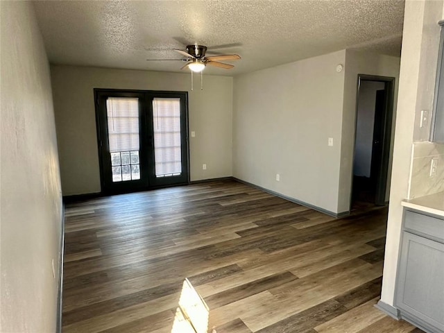 unfurnished room featuring french doors, hardwood / wood-style floors, and a textured ceiling