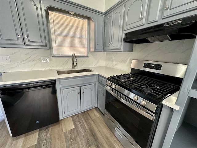 kitchen with sink, gray cabinets, stainless steel gas range oven, and dishwasher