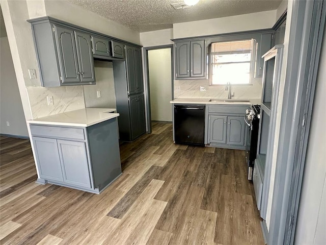 kitchen with sink, dishwasher, gray cabinetry, and stainless steel gas stove