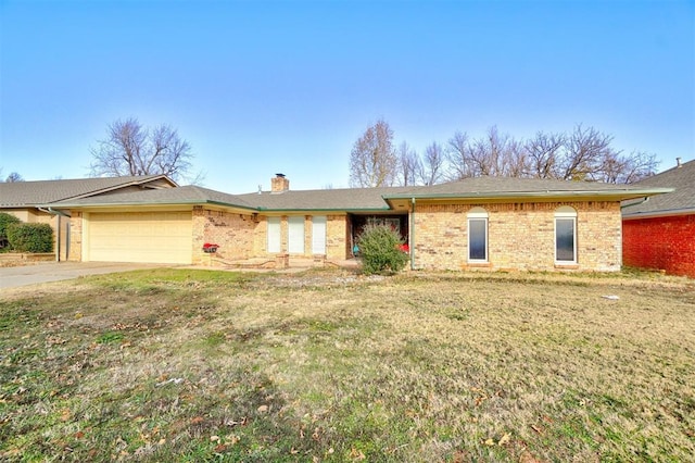 single story home featuring a garage and a front lawn