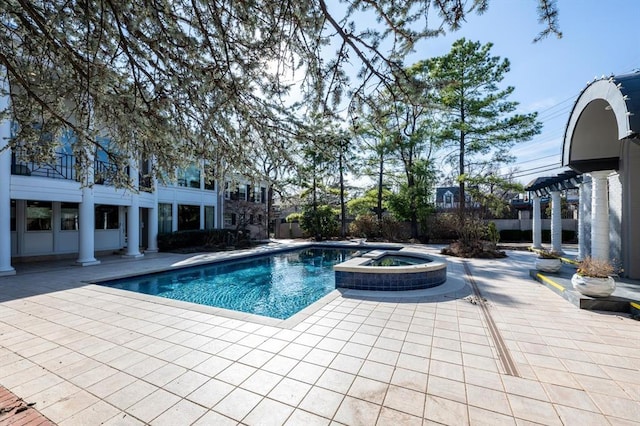 view of swimming pool with a patio and an in ground hot tub