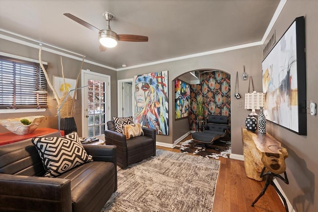 sitting room featuring ceiling fan, crown molding, and wood-type flooring