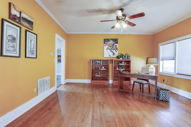 home office featuring hardwood / wood-style flooring, ceiling fan, and ornamental molding