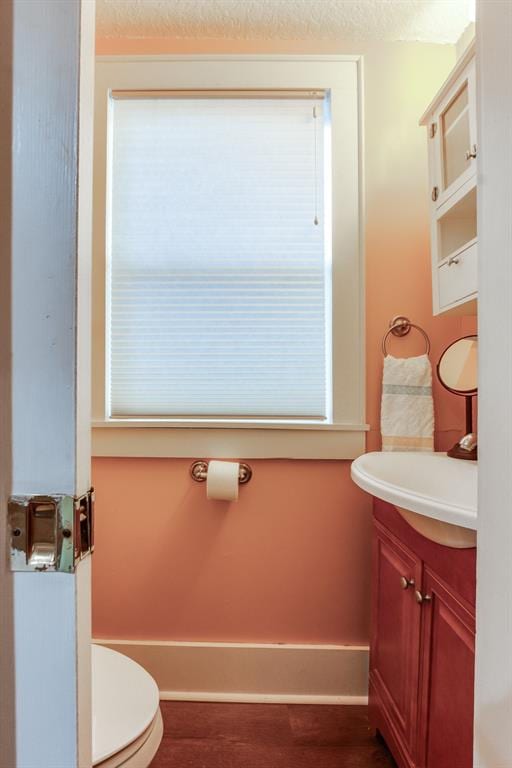 bathroom with vanity, a textured ceiling, and toilet