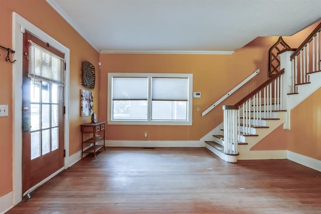 interior space featuring hardwood / wood-style flooring, plenty of natural light, and crown molding