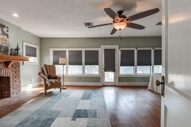 interior space with ceiling fan and a fireplace