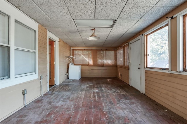 interior space featuring washer / clothes dryer and wooden walls