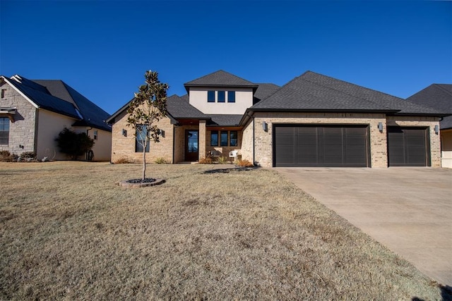 view of front facade with a front yard and a garage