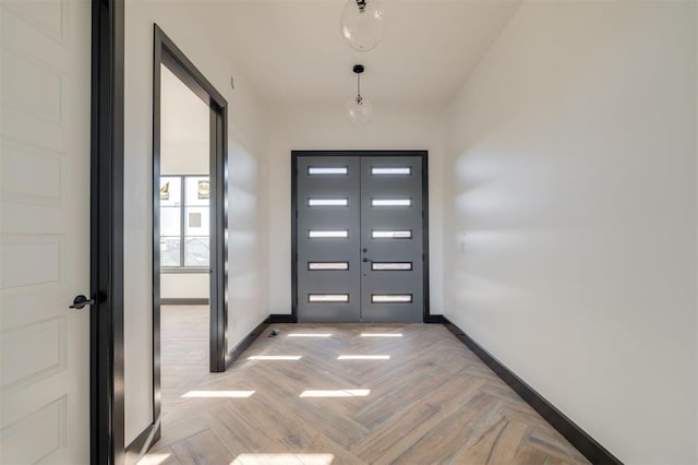 entryway with french doors and light parquet floors