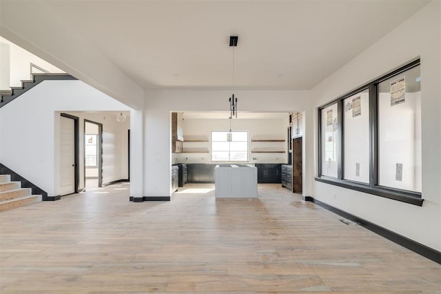 unfurnished living room featuring light wood-type flooring