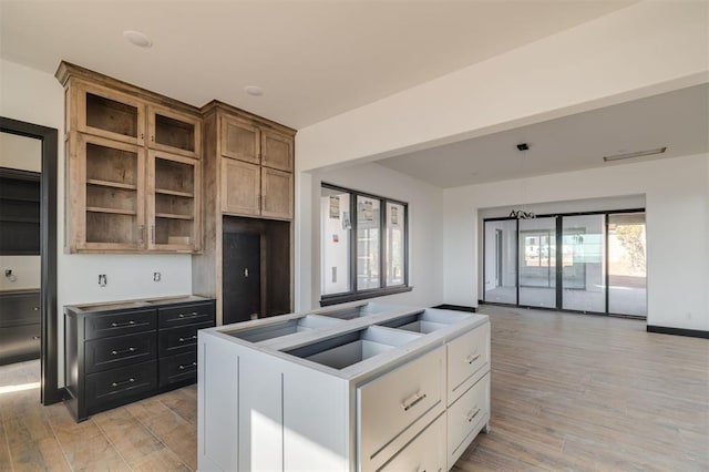 kitchen with sink, white cabinetry, and light hardwood / wood-style floors