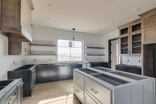 kitchen with hanging light fixtures and light wood-type flooring