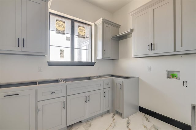 laundry room featuring washer hookup and cabinets