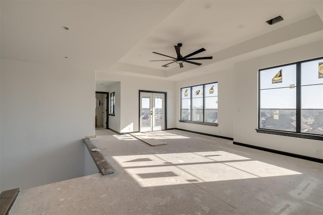 spare room with french doors, ceiling fan, and a tray ceiling