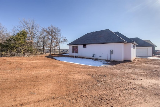 back of property with a garage