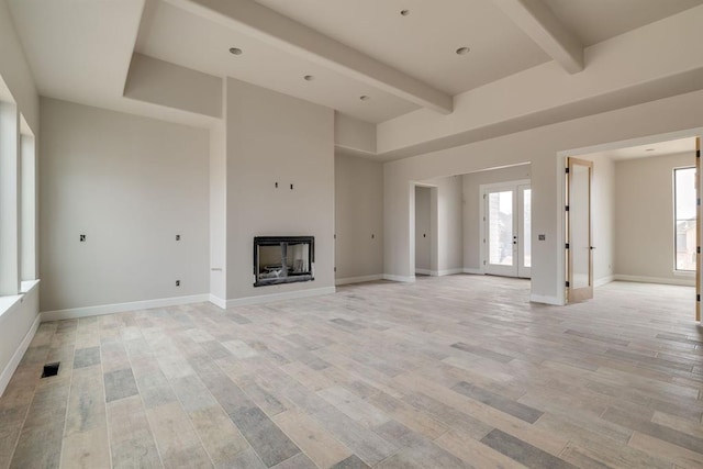 unfurnished living room featuring beam ceiling