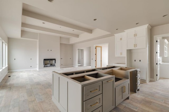 kitchen featuring white cabinetry, gray cabinetry, and a kitchen island