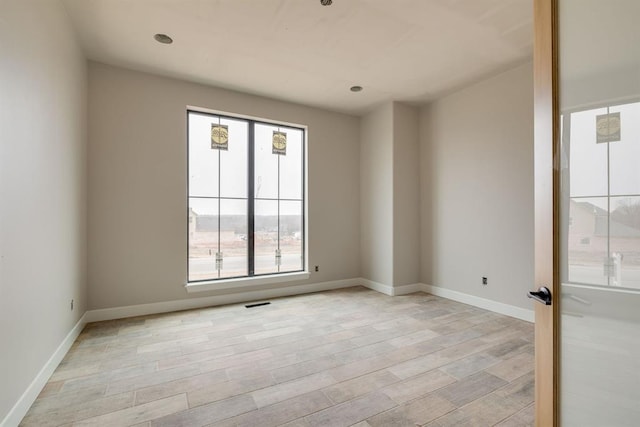 empty room with light hardwood / wood-style floors