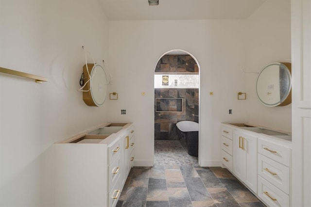 bathroom featuring a tub and vanity