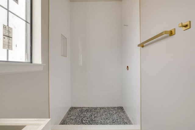 bathroom with tiled shower