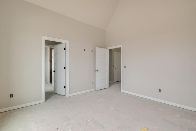 unfurnished bedroom featuring high vaulted ceiling