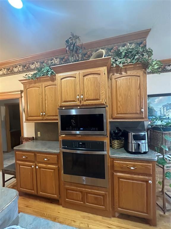 kitchen with stainless steel appliances and light hardwood / wood-style flooring