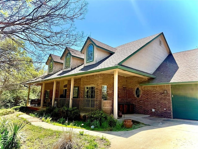 view of front of property with driveway, an attached garage, brick siding, a porch, and a shingled roof