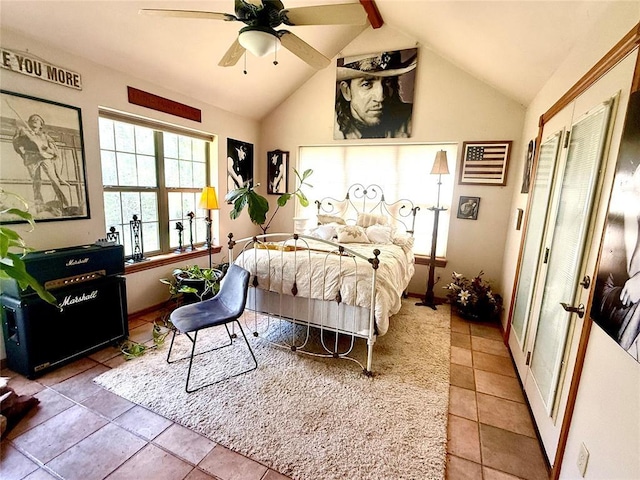 tiled bedroom featuring vaulted ceiling with beams and a ceiling fan