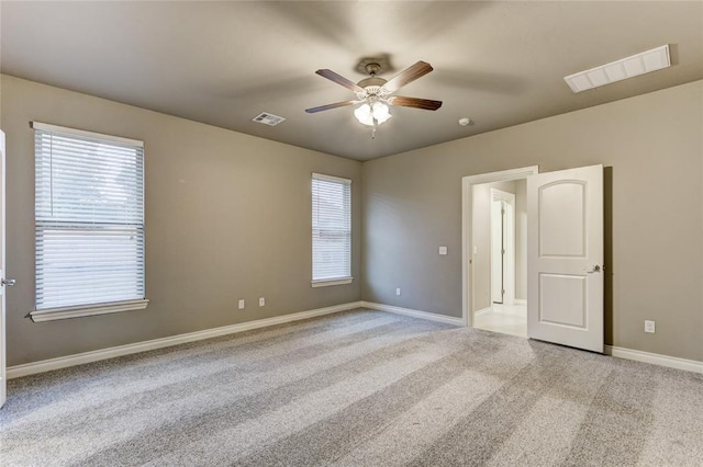 carpeted empty room featuring ceiling fan