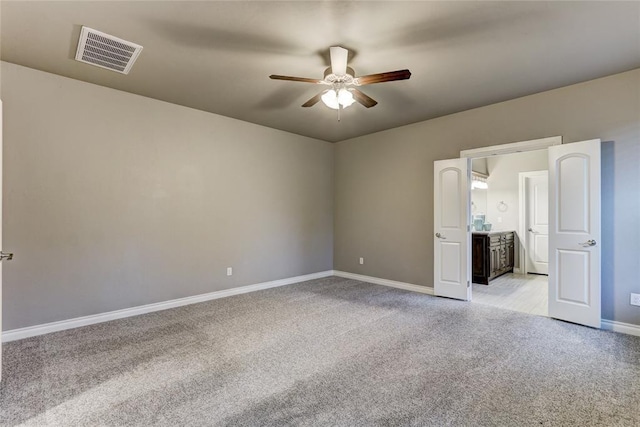 unfurnished bedroom with ceiling fan and light colored carpet