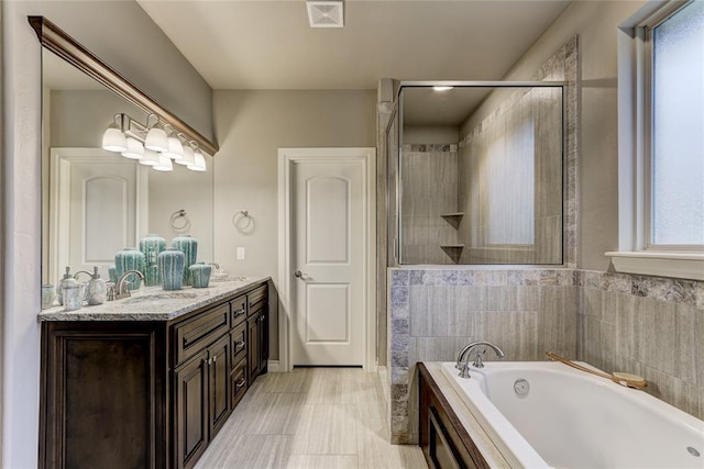 bathroom featuring vanity, tile walls, and independent shower and bath