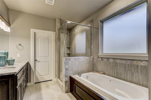 bathroom featuring vanity and plus walk in shower