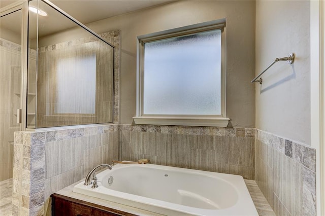 bathroom featuring a relaxing tiled tub