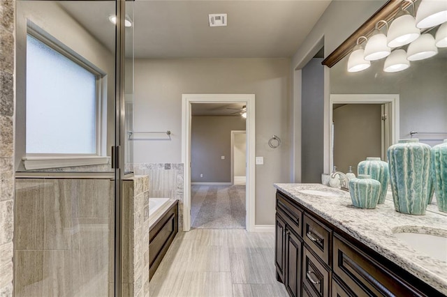 bathroom with separate shower and tub and vanity