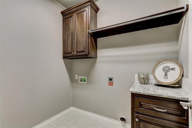 washroom with washer hookup, electric dryer hookup, and cabinets