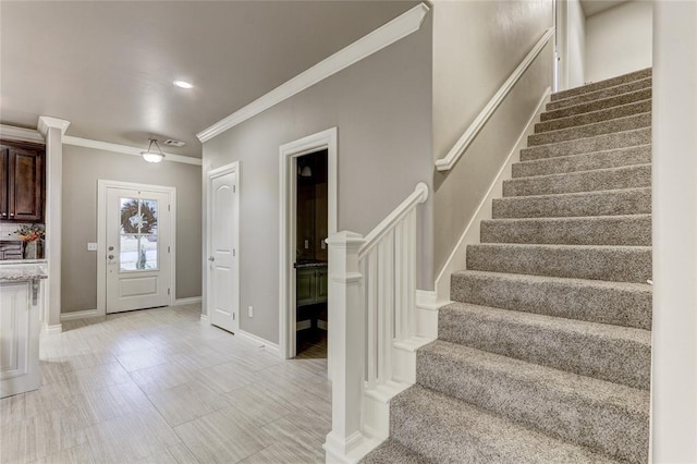 foyer entrance featuring crown molding