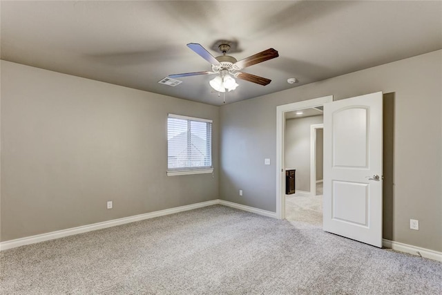 empty room featuring light colored carpet and ceiling fan