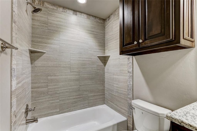 full bathroom with tiled shower / bath combo, toilet, and vanity