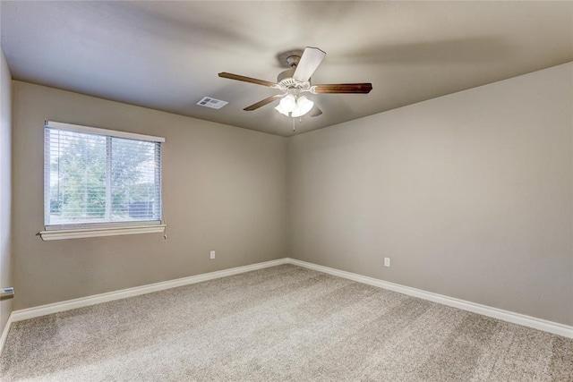 empty room with ceiling fan and carpet