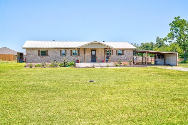 ranch-style house featuring a front lawn and a carport