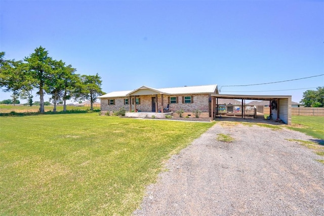 single story home featuring a front lawn and a carport