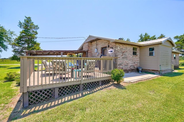 back of house featuring a deck and a lawn